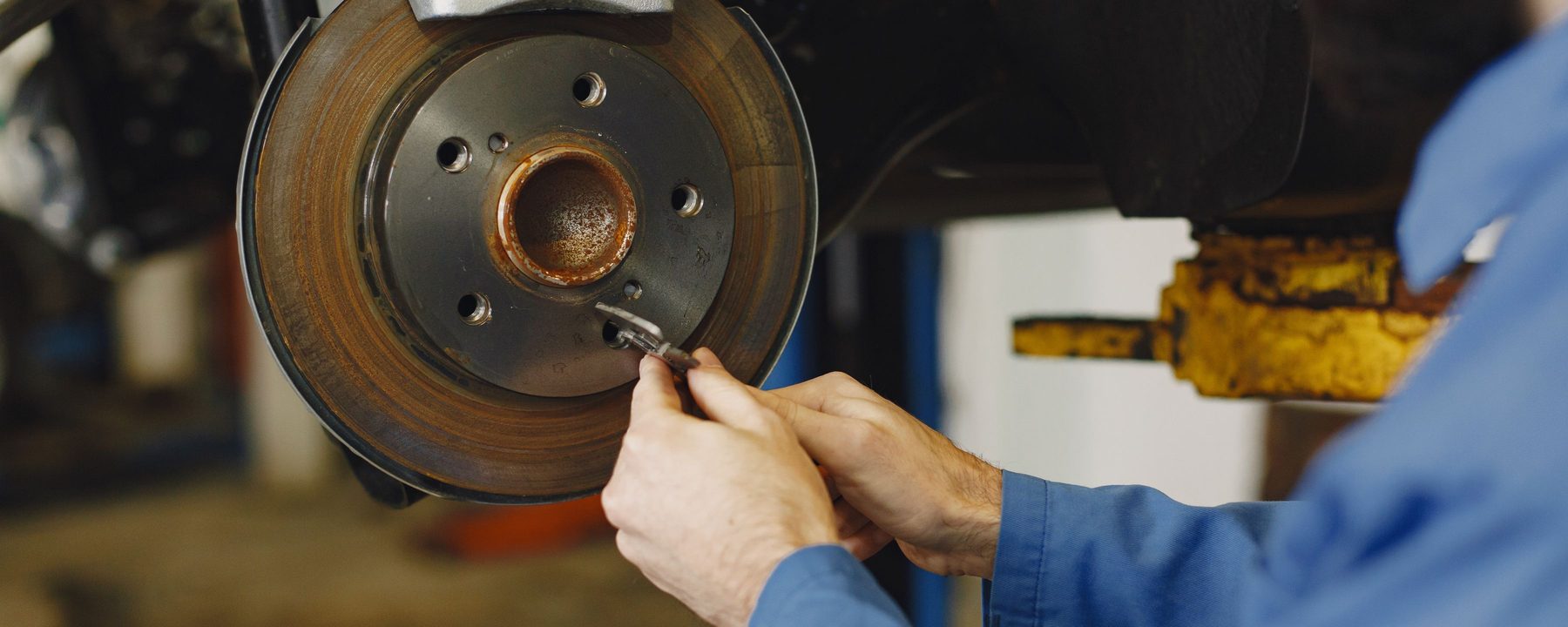 A mechanic checking a brake disc
