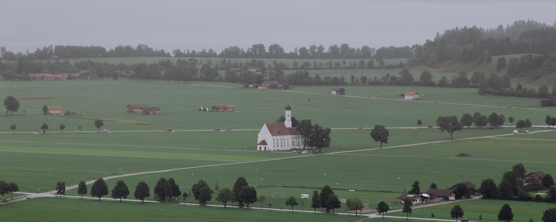 Flat Bavarian countryside with a church and fields