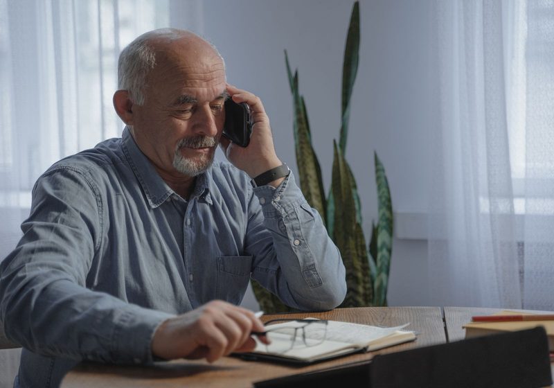 A business owner on the phone at his desk