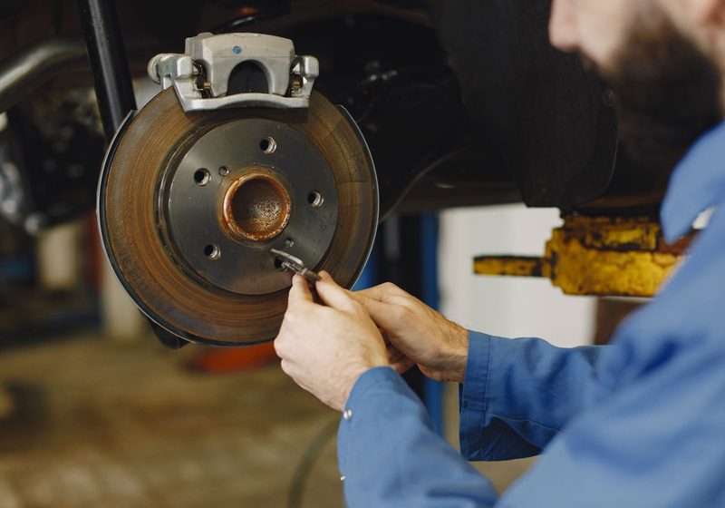 A mechanic checking a brake disc